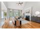 Open-concept living room with vaulted ceilings, fireplace, and ample natural light through large windows at 532 Joe Collins Rd, Lillington, NC 27546