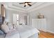 Relaxing main bedroom with tray ceilings, hardwood floors, and plenty of natural light at 532 Joe Collins Rd, Lillington, NC 27546