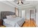 Comfortable main bedroom with tray ceilings, hardwood floors, and ensuite bathroom access at 532 Joe Collins Rd, Lillington, NC 27546