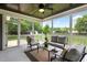Cozy screened porch with comfortable seating, a ceiling fan, and views of the backyard at 532 Joe Collins Rd, Lillington, NC 27546