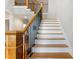 Staircase with light hardwood steps, white risers, and black metal railing at 532 Joe Collins Rd, Lillington, NC 27546