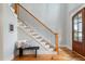 Staircase featuring wood steps, black iron railings, and a modern, minimalist aesthetic at 532 Joe Collins Rd, Lillington, NC 27546