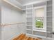 Spacious walk-in closet with custom built-in shelving and natural light at 532 Joe Collins Rd, Lillington, NC 27546