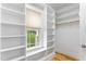 Spacious walk-in closet with custom built-in shelving and natural light at 532 Joe Collins Rd, Lillington, NC 27546