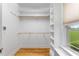 Bright walk-in closet with custom built-in shelving and natural light at 532 Joe Collins Rd, Lillington, NC 27546