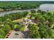 Overhead shot of a golf course clubhouse surrounded by lush greenery and trees, showcasing a scenic retreat for leisure at 6102 Burning Tree Cir, Sanford, NC 27332