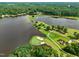 Stunning aerial view of a golf course and lakefront home, showcasing a serene and picturesque landscape at 6102 Burning Tree Cir, Sanford, NC 27332