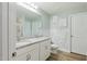 Bright bathroom with double vanity, granite counters, stylish wallpaper, and glass shower at 6102 Burning Tree Cir, Sanford, NC 27332