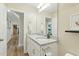 A bright bathroom with a granite countertop and white cabinets creates a clean and inviting atmosphere for daily routines at 6102 Burning Tree Cir, Sanford, NC 27332
