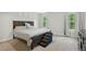 Bedroom with a dark wood frame bed and minimal decoration with light from a nearby window at 6102 Burning Tree Cir, Sanford, NC 27332