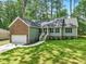 Charming single-Gathering home boasts stone accents, a manicured lawn, and an attached two-car garage at 6102 Burning Tree Cir, Sanford, NC 27332