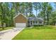 Charming single-story home featuring a stone facade, attached garage, and well-manicured lawn at 6102 Burning Tree Cir, Sanford, NC 27332