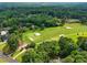Aerial view of a meticulously maintained golf course surrounded by lush greenery and beautiful homes at 6102 Burning Tree Cir, Sanford, NC 27332