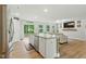 Bright, open kitchen with granite island and stainless appliances, flows into living area at 6102 Burning Tree Cir, Sanford, NC 27332