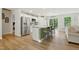 Modern kitchen with a large island, stainless steel appliances, granite countertops, and a sliding glass door at 6102 Burning Tree Cir, Sanford, NC 27332