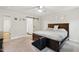 Cozy primary bedroom featuring a large bed, barn door entry to the bathroom and plenty of natural light at 6102 Burning Tree Cir, Sanford, NC 27332