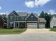 Charming two-story home with a three car garage and a beautifully landscaped front yard at 7008 Rex, Holly Springs, NC 27540