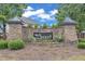 Stone entrance sign for Avocet featuring lush landscaping and manicured plants at 7008 Rex, Holly Springs, NC 27540