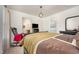 Bright bedroom with a rocking chair, neutral walls, and an ensuite bathroom at 71 Sanibel St, Clayton, NC 27520