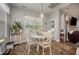 Cozy dining area with a round table, cushioned chairs, a large window, and decorative accents at 71 Sanibel St, Clayton, NC 27520