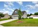 View of the home's facade showcasing a landscaped front yard, a two-car garage, and the property's exterior at 71 Sanibel St, Clayton, NC 27520