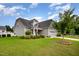 Beautiful home exterior displaying lush landscaping, a manicured lawn, and a well-maintained facade at 71 Sanibel St, Clayton, NC 27520