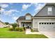 Home exterior with attractive landscaping, a two-car garage, and a charming front porch with rocking chairs at 71 Sanibel St, Clayton, NC 27520
