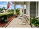 Welcoming front porch with rocking chairs, decorative plants, and stone accents, creating a cozy outdoor space at 71 Sanibel St, Clayton, NC 27520