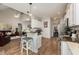Open kitchen with an island, white cabinets, hardwood floors, and an adjoining living and dining area at 71 Sanibel St, Clayton, NC 27520
