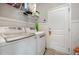 Functional laundry room featuring a washer and dryer, storage shelves, and a practical design at 71 Sanibel St, Clayton, NC 27520
