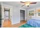 Bedroom with wooden floors, closet, and windows offering ample natural light at 7132 Deer Brook St, Willow Springs, NC 27592