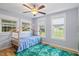 Light-filled bedroom featuring three large windows and a unique bed frame at 7132 Deer Brook St, Willow Springs, NC 27592