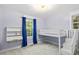 A cozy bedroom featuring a modern loft bed and built-in desk with natural light at 7132 Deer Brook St, Willow Springs, NC 27592
