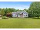 Charming home with a well-maintained lawn, lovely landscaping, and a welcoming front porch at 7132 Deer Brook St, Willow Springs, NC 27592