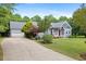 Charming home with a well-manicured lawn, inviting front porch, and an attached garage for convenience at 7132 Deer Brook St, Willow Springs, NC 27592