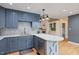 Modern kitchen with shaker cabinets, stainless steel appliances, quartz countertop, and decorative backsplash at 7132 Deer Brook St, Willow Springs, NC 27592