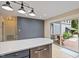 Bright, modern kitchen with an island, stainless steel appliances, and an adjacent outdoor deck and backyard at 7132 Deer Brook St, Willow Springs, NC 27592