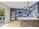 Beautiful kitchen with stainless steel appliances, custom cabinetry, and a sliding door leading to an outdoor deck at 7132 Deer Brook St, Willow Springs, NC 27592