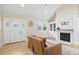 Cozy living room with fireplace, built-in shelving, and natural light through large windows at 7132 Deer Brook St, Willow Springs, NC 27592