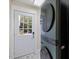 Mud Room with side door, tile flooring, and stackable washer and dryer at 7132 Deer Brook St, Willow Springs, NC 27592