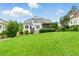 Expansive backyard featuring lush green lawn and well-maintained landscaping with a screened-in porch at 77 Ruffed Grouse, Chapel Hill, NC 27517