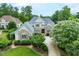 Elegant home with a stone and siding facade, complemented by lush landscaping and a curved driveway at 77 Ruffed Grouse, Chapel Hill, NC 27517