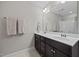 Bathroom with double vanity, marble countertop, large mirror and modern lighting at 81 Dot Ct, Fuquay Varina, NC 27526