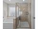 Bathroom featuring a glass enclosed shower and a garden tub with patterned window at 81 Dot Ct, Fuquay Varina, NC 27526