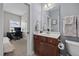 A bathroom with a wood vanity, mirror, and a toilet at 81 Dot Ct, Fuquay Varina, NC 27526