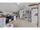Bright bedroom featuring neutral walls, carpet, built-in storage, a work area, and a whimsical dollhouse at 81 Dot Ct, Fuquay Varina, NC 27526