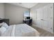 A simple bedroom with a work space near the window and closet at 81 Dot Ct, Fuquay Varina, NC 27526