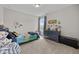 Bedroom with blue dresser, plush carpets, and large window for natural light at 81 Dot Ct, Fuquay Varina, NC 27526
