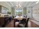 Elegant dining room with large windows, a stylish chandelier, and ample seating at 81 Dot Ct, Fuquay Varina, NC 27526
