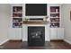 Close up of a gas fireplace with decorative mantle and surrounding built-in shelving at 81 Dot Ct, Fuquay Varina, NC 27526